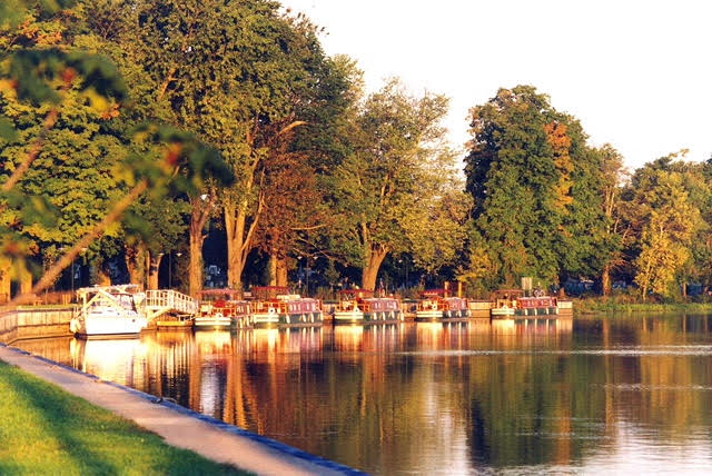 showing the leaves just turning in fall along the Erie Canal